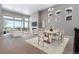Open concept dining room with a large table and access to living room at 3893 Freestone Pt, Castle Rock, CO 80108
