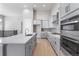 Modern kitchen with gray cabinets, quartz countertops, and stainless steel appliances at 3893 Freestone Pt, Castle Rock, CO 80108