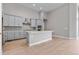Island kitchen with light gray cabinets and quartz countertops at 3893 Freestone Pt, Castle Rock, CO 80108