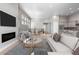 Open living room with fireplace, hardwood floors, and modern furniture at 3893 Freestone Pt, Castle Rock, CO 80108