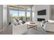 Spacious living room with large windows, fireplace and view of deck and hills at 3893 Freestone Pt, Castle Rock, CO 80108