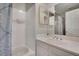 Clean bathroom features tiled shower/tub with a shower curtain and single sink vanity with mirror at 7557 S Cove Cir, Centennial, CO 80122