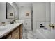 Beautiful bathroom showcasing a modern vanity with marble countertops and tiled shower with a glass door at 7557 S Cove Cir, Centennial, CO 80122