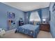 Charming bedroom with a cozy bed, ample natural light, and playful decor at 7557 S Cove Cir, Centennial, CO 80122