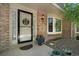 Inviting front porch with brick facade, bay window, and decorative flower pots create a warm welcome at 7557 S Cove Cir, Centennial, CO 80122