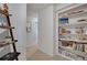 Hallway with a built-in bookcase filled with books and decorative items at 7557 S Cove Cir, Centennial, CO 80122