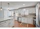 Bright kitchen featuring stainless steel appliances, white cabinets, and granite countertops at 7557 S Cove Cir, Centennial, CO 80122