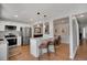 Bright kitchen features an island with barstool seating, granite countertops, and stainless steel appliances at 7557 S Cove Cir, Centennial, CO 80122