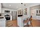 Bright kitchen features an island with barstool seating, granite countertops, and stainless steel appliances at 7557 S Cove Cir, Centennial, CO 80122