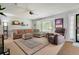 Bright living room with large sectional, fireplace, and view of front entrance providing comfort and style at 7557 S Cove Cir, Centennial, CO 80122