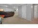 Spacious living area featuring a comfortable leather sofa, carpeted floor, and white trim at 7557 S Cove Cir, Centennial, CO 80122
