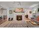 Comfortable living room with fireplace, carpeted floors, and access to other rooms at 7557 S Cove Cir, Centennial, CO 80122