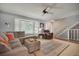 Inviting living room features a cozy sectional, large windows, and a staircase for a comfortable atmosphere at 7557 S Cove Cir, Centennial, CO 80122