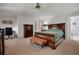 This primary bedroom offers great space with a dark wood furniture set and ensuite bath at 7557 S Cove Cir, Centennial, CO 80122