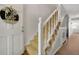 Entryway with a carpeted staircase and white railing, leading to the upper levels of the home at 7557 S Cove Cir, Centennial, CO 80122