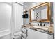 Stylish bathroom featuring granite counters, a bathtub with white tile, and modern black fixtures at 21005 Glacier Park Cv, Parker, CO 80138