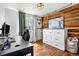 Inviting bedroom featuring hardwood floors, wood accent wall, and large windows for natural light at 21005 Glacier Park Cv, Parker, CO 80138