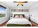 Comfortable bedroom with hardwood floors, fan, ample natural light, and stylish decor for relaxing at 21005 Glacier Park Cv, Parker, CO 80138
