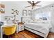 Cozy bedroom with hardwood floors, ceiling fan, lots of natural light, and decorative wall accents at 21005 Glacier Park Cv, Parker, CO 80138