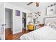 Bright bedroom featuring a walk-in closet, wooden floors, and a cozy desk area with natural light at 21005 Glacier Park Cv, Parker, CO 80138