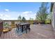Outdoor deck with a dining table, chairs, and a view of the backyard and neighborhood at 21005 Glacier Park Cv, Parker, CO 80138