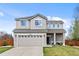 Charming two-story home boasts a manicured lawn, attached two-car garage and a welcoming covered porch at 21005 Glacier Park Cv, Parker, CO 80138