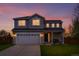 Charming two-story home featuring a well-manicured lawn and an attached two-car garage at 21005 Glacier Park Cv, Parker, CO 80138