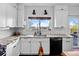 Modern kitchen featuring granite countertops, white cabinets, and stainless steel appliances at 21005 Glacier Park Cv, Parker, CO 80138