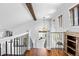 Bright stairwell featuring hardwood floors, a decorative wood beam, and black metal railings at 21005 Glacier Park Cv, Parker, CO 80138