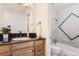 Charming bathroom with a classic vanity, black countertops, and a tiled shower-tub combo at 7902 Chase Cir # 152, Arvada, CO 80003