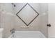 This bathroom features a classic tub with attractive beige and brown accent tiling at 7902 Chase Cir # 152, Arvada, CO 80003