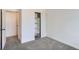 This bedroom features plush carpeting, a closet with shelving, and crisp white walls at 7902 Chase Cir # 152, Arvada, CO 80003
