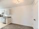 Bright kitchen featuring white cabinets, gray countertop, a sink, and a white dishwasher at 7902 Chase Cir # 152, Arvada, CO 80003