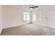 Minimalist living room featuring neutral carpet, fresh paint, ceiling fan, and natural light at 7902 Chase Cir # 152, Arvada, CO 80003