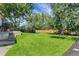 Spacious backyard featuring lush green grass and shade trees, ideal for outdoor activities and enjoyment at 10863 W 67Th Pl, Arvada, CO 80004