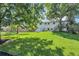 Spacious and shady backyard with mature trees, lush green lawn, and plenty of room to relax or play at 10863 W 67Th Pl, Arvada, CO 80004