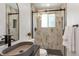Modern bathroom with stylish vessel sink, walk-in shower, and elegant tiling at 10863 W 67Th Pl, Arvada, CO 80004