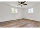 Spacious bedroom with natural light, wood-look flooring, and a ceiling fan at 10863 W 67Th Pl, Arvada, CO 80004