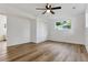 This bedroom includes hard wood floors, a ceiling fan, a window, and a closet at 10863 W 67Th Pl, Arvada, CO 80004