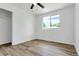 Well-lit bedroom with hardwood floors, a ceiling fan, a window, and a closet at 10863 W 67Th Pl, Arvada, CO 80004