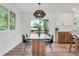 Modern dining area featuring stylish light fixture and outdoor view at 10863 W 67Th Pl, Arvada, CO 80004