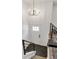 Stylish entryway showcasing a modern chandelier, black-tiled floor, and staircase with black railings at 10863 W 67Th Pl, Arvada, CO 80004