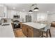 Modern kitchen features stainless steel appliances, shaker cabinets, and large island with seating at 10863 W 67Th Pl, Arvada, CO 80004