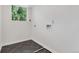 Bright laundry room featuring sleek tile flooring, natural light, and modern washer and dryer hookups at 10863 W 67Th Pl, Arvada, CO 80004