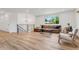 Bright, modern living room with large window and comfortable leather sofa at 10863 W 67Th Pl, Arvada, CO 80004