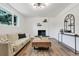 Bright living room with hardwood floors, fireplace, modern light fixture, and neutral decor at 10863 W 67Th Pl, Arvada, CO 80004