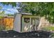 Charming backyard shed with decorative accents, perfect for extra storage or a workshop space at 10863 W 67Th Pl, Arvada, CO 80004