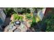 Overhead view of backyard with a seating area, fire pit, and well-maintained raised garden beds for sustainable living at 16367 E Auburn Hills Dr, Parker, CO 80134