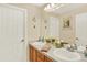 Bathroom features dual sinks, a large mirror, and classic white doors at 16367 E Auburn Hills Dr, Parker, CO 80134
