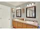 Well-lit bathroom featuring double sinks, mirrors, and ample storage at 16367 E Auburn Hills Dr, Parker, CO 80134